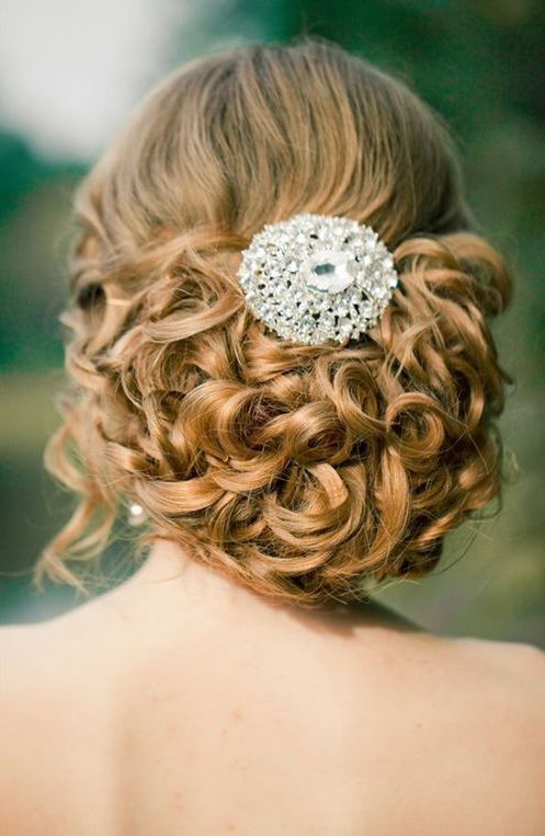 curled updo with a cool jewel hairpiece