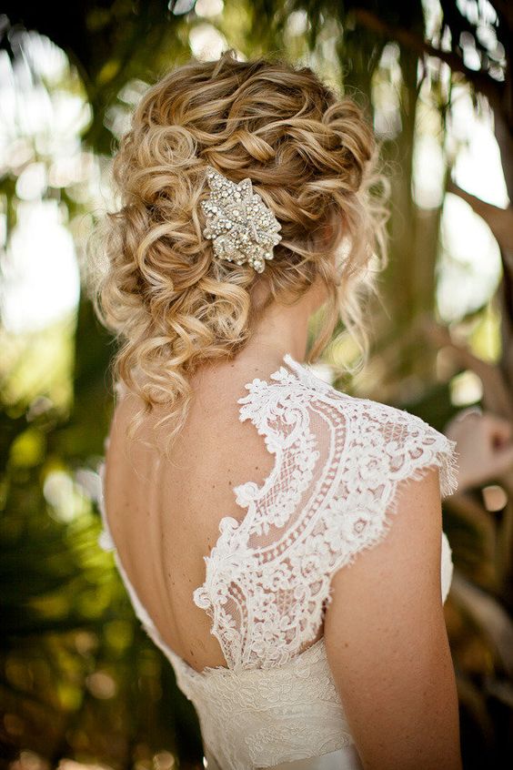 messy curled updo wwith a chic vintage jewel