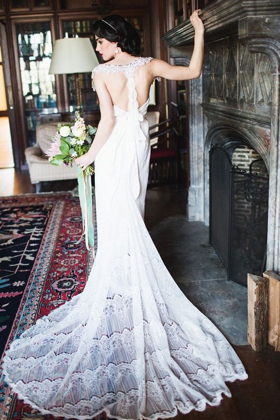 relaxed wedding gown with a train and a lace racerback with a bow