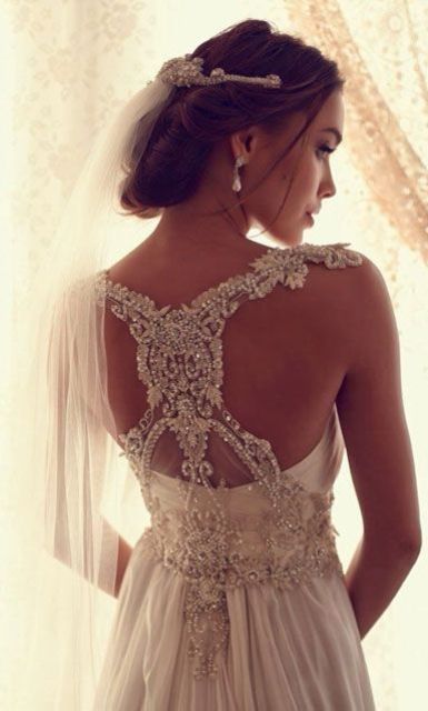 stunning lace and jeweled racerback of your wedding dress will make everyone look at you