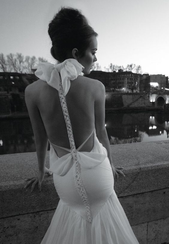 couture wedding dress with a mermaid silhouette and a racerback with a big bow
