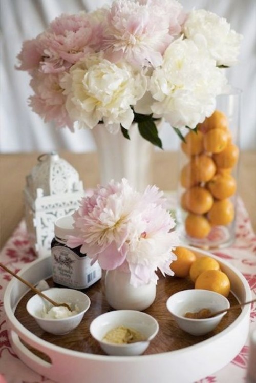 a tray with various masks, blush and neutral blooms and citrus for decor or to add to the masks