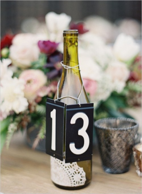 a bottle table number with a doilly is a lovely and pretty idea to style your table and mark its number