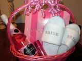 a pink basket with slippers, wine, a perfume and a cute Victoria’s Secret box is a glam morning gift for your girl