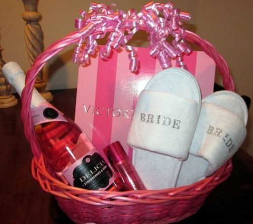 a pink basket with slippers, wine, a perfume and a cute Victoria's Secret box is a glam morning gift for your girl