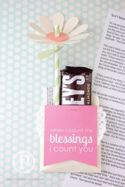 a box with her favorite chocolate and a paper flower is a cute and fun idea for each girl