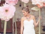 pink oversized blooms can be used as a wedding photo booth at a spring or summer wedding