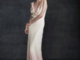 a sleeveless dip dye pink and white wedding dress with a deep neckline, draped bodice and a fabric bloom on it