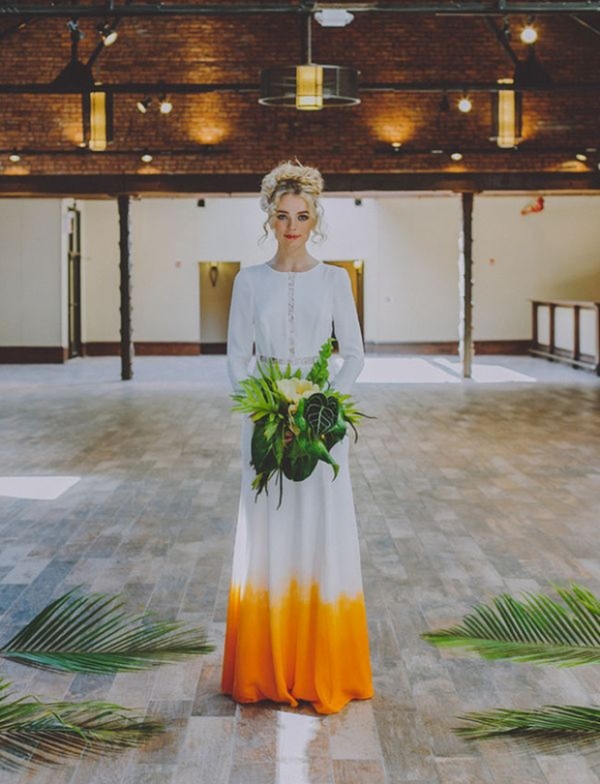 A boho dip dye wedding dress in white and yellow and with lace inserts for a statement like boho look