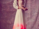 an A-line blush and red dip dye wedding dress paired with a lace cardigan for an out-of-the-box bridal look