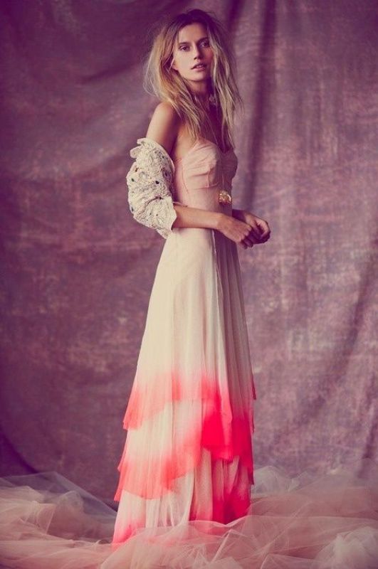 an A line blush and red dip dye wedding dress paired with a lace cardigan for an out of the box bridal look