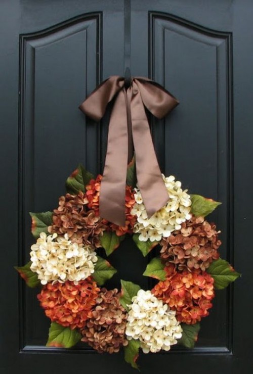 a bright vintage fall wreath with fresh white and rust hydrangeas and brown dired ones, with leaves and an elegant brown ribbon bow is wow