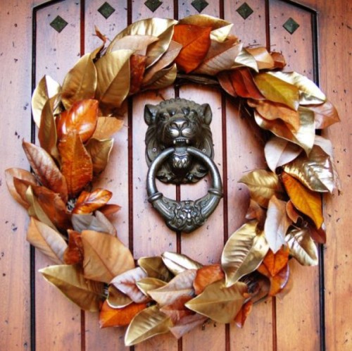 a colorful fall wedding wreath of gilded, silver and orange painted leaves is a very cool and fresh idea for decor