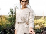 a boho bridal look with a braided updo and a neutral braided sweater for covering up is a great idea for a winter boho wedding