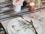 sticks, greenery and a glass ornament with greenery for decorating a winter boho wedding