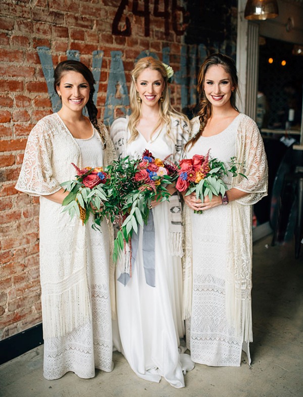 White crochet boho bridesmaid dresses plus lace coverups and bright blooms are perfect for a boho winter wedding