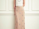 a romantic look with a white embellished top and a tan embellished maxi skirt