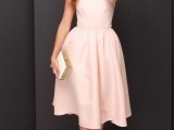 an elegant blush midi halter neckline plain dress with a full skirt, white heels and a white clutch with a metallic edge