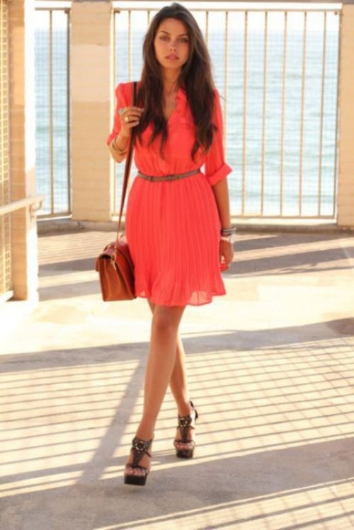 a neon pink knee dress with long sleeves, a belt and platform shoes plus an amber bag for summer