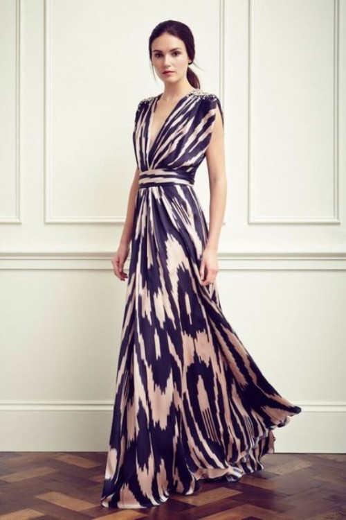a bold printed sleeveless maxi dress with a deep neckline and embellished shoulders for a comfortable and chic look
