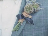 a light blue checked suit, a white shirt and a white bow tie plus a greenery boutonniere
