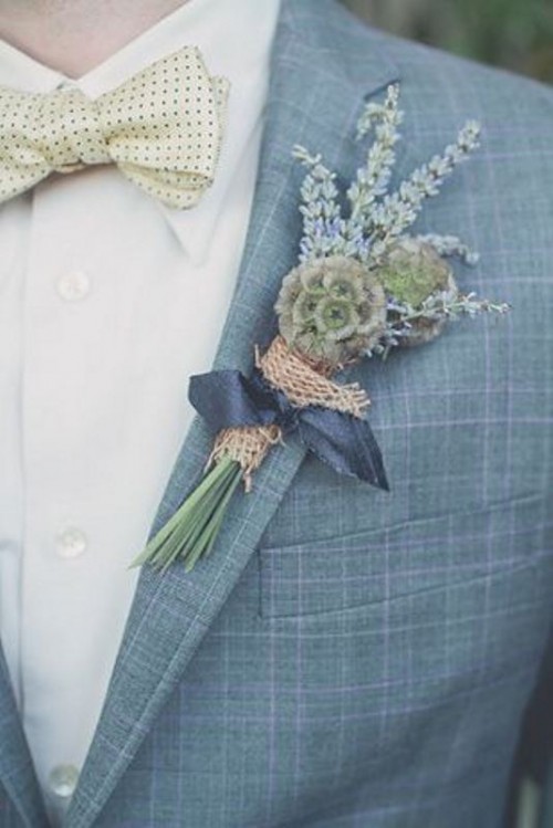 a light blue checked suit, a white shirt and a white bow tie plus a greenery boutonniere