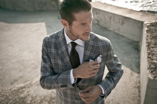a cool grey plaid pantsuit with a white shirt and a black tie is a stylish modern solution