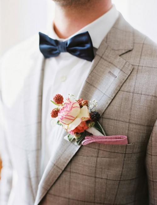 a grey windowppane suit, a white shirt, a black bow tie for a catchy look at the wedding
