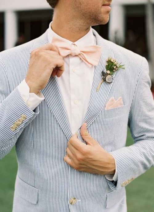 a coastal gorom's look with a light blue striped suit, a white shirt and a pink bow tie is very airy