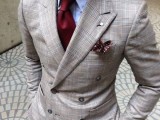 a grey plaid pantsuit, a blue shirt and a burgundy tie are a cool and catchy look for a fall wedding