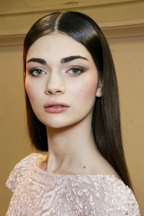 a delicate and fresh makeup with a shiny blush lip, grey smokeys, accented eyebrows, a slight touch of blush is cool