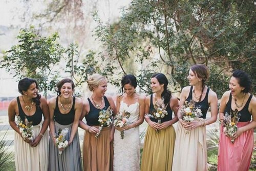 black tank tops with mismatching white, grey, pink and mustard pleated maxi skirts are a great combo for a summer or summer to fall wedding