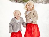 white tops, bright red skirts, grey crochet cardigans and simple shoes will keep your flower girls warm and they will look stylish