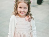 a blush lace dress paired with a white crochet cardigan are a stylish combo to rock, perfect for a winter flower girl