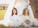 white long sleeve tops, white tulle skirts and white flwoer crowns for a chic winter flower girl look