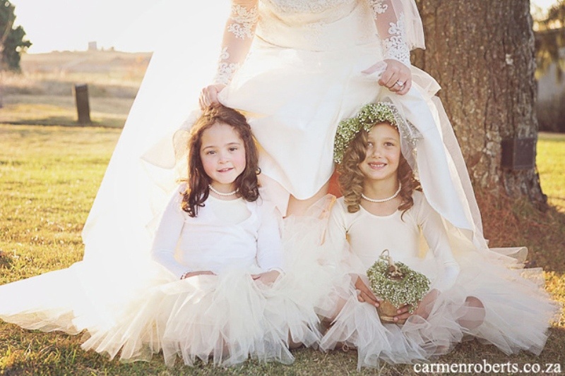 white long sleeve tops, white tulle skirts and white flwoer crowns for a chic winter flower girl look