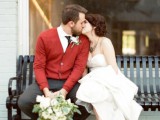 grey pants, a white shirt, a black tie and a coral cardigan for a comfy and bright wedding look