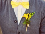 a white shirt, a grey cardigan, a yellow bow tie and a yellow boutonniere for a bright and shiny groom’s outfit