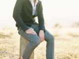 grey pants, a white shirt, a black cardigan and brown moccasins for a simple and casual groom’s look