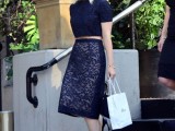 a navy combo of a lace crop top with a high neckline and short sleeves and a midi pencil skirt plus blue shoes