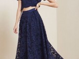 a navy lace ensemble with a crop top with short sleeves and a maxi skirt looks bold and statement-like