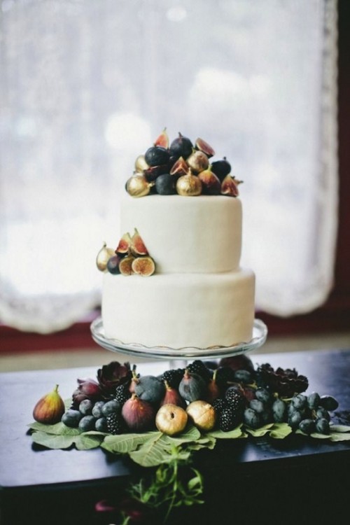 a sleek and plain white wedding cake topped with gilded figs is a gorgeous idea for a fall wedding