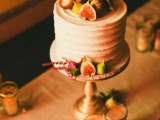 a white textural wedding cake topped with figs and dried blooms is a stylish idea for a fall wedding