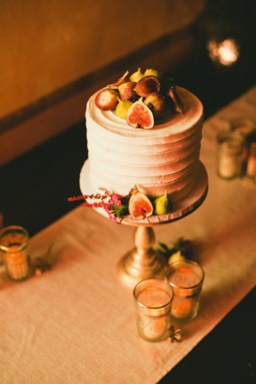 a white textural wedding cake topped with figs and dried blooms is a stylish idea for a fall wedding
