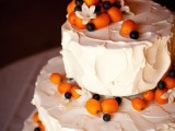 a three-tier white textural wedding cake topped with fresh kumquat and blueberries is a creative and cool idea for a summer wedding