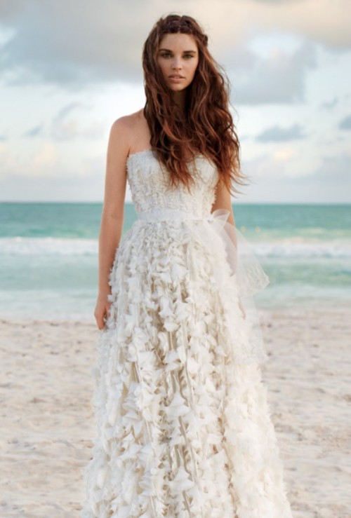 a romantic strapless A-line wedding dress with floral appliques and a tulle sash is a beautiful idea for a beach wedding