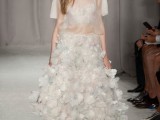a unique wedding dress with a sheer bodice and a floral petal midi skirt, lace up shoes is a fashion-forward idea