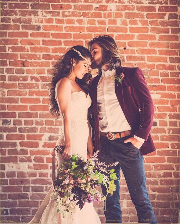 A relaxed boho groom's look with grey pants, a burgundy velvet blazer and a white shirt for the fall