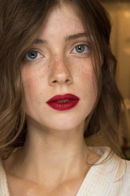 a bold makeup with slightly accented eyes, blush and a bold lip for a statement