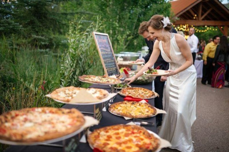 a large pizza bar with pizzas on stands, under which you can place tealights and a chalkboard sign with a menu